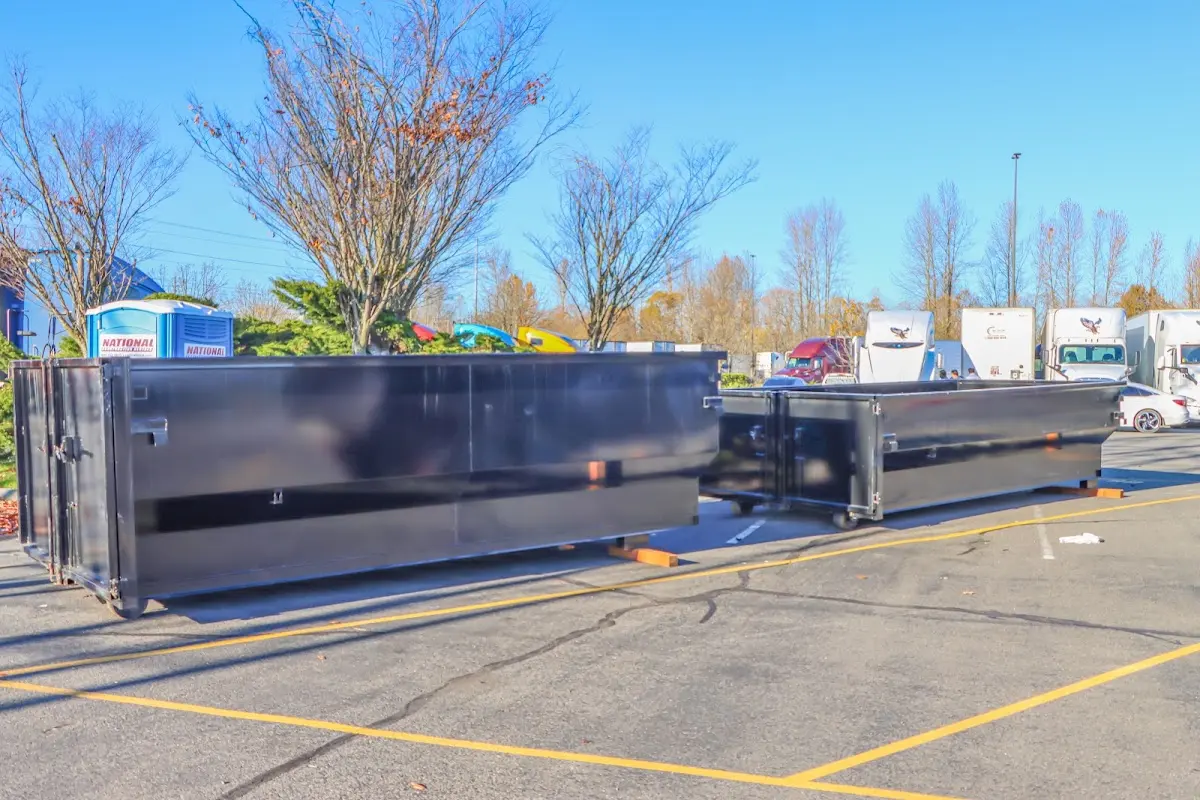 Professional dumpster rental service with roll-off container on residential driveway in Dickson City